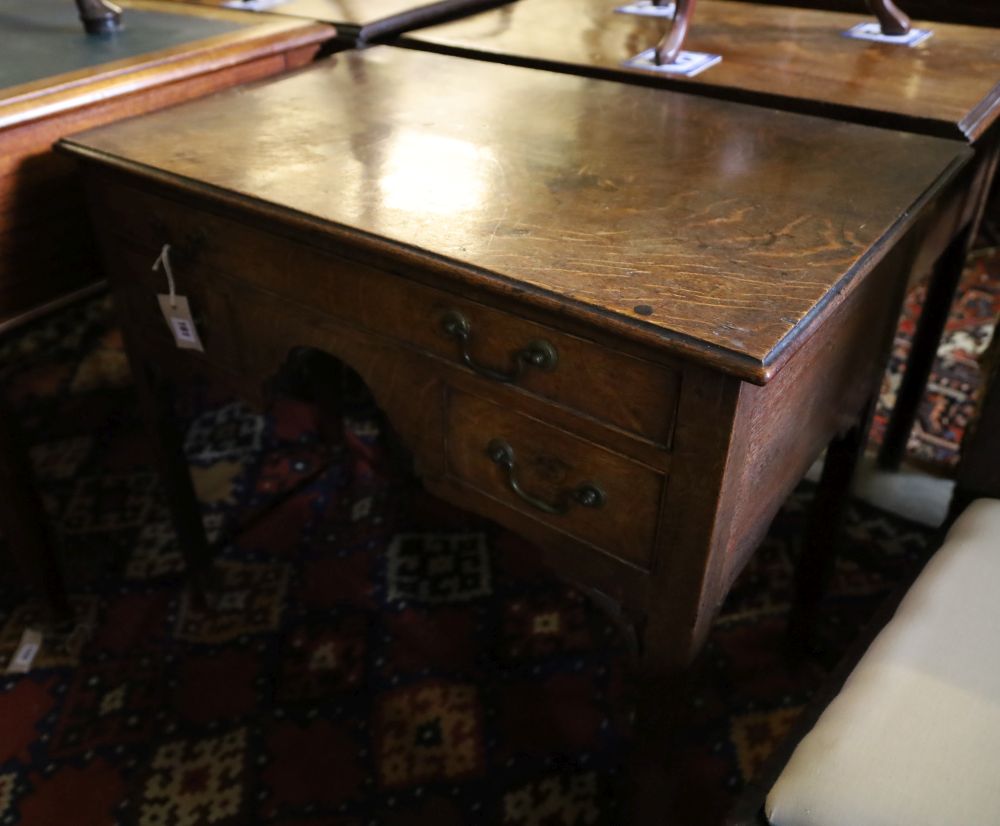 A George III oak low boy, with one long and two short drawers, with brass drop handles, on square section supports, width 79cm, depth 4